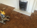 Mosaic parquet repairs to fireplace Shaftesbury