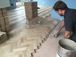 Solid oak Herringbone parquet flooring installed with two block boarder by our craftsman