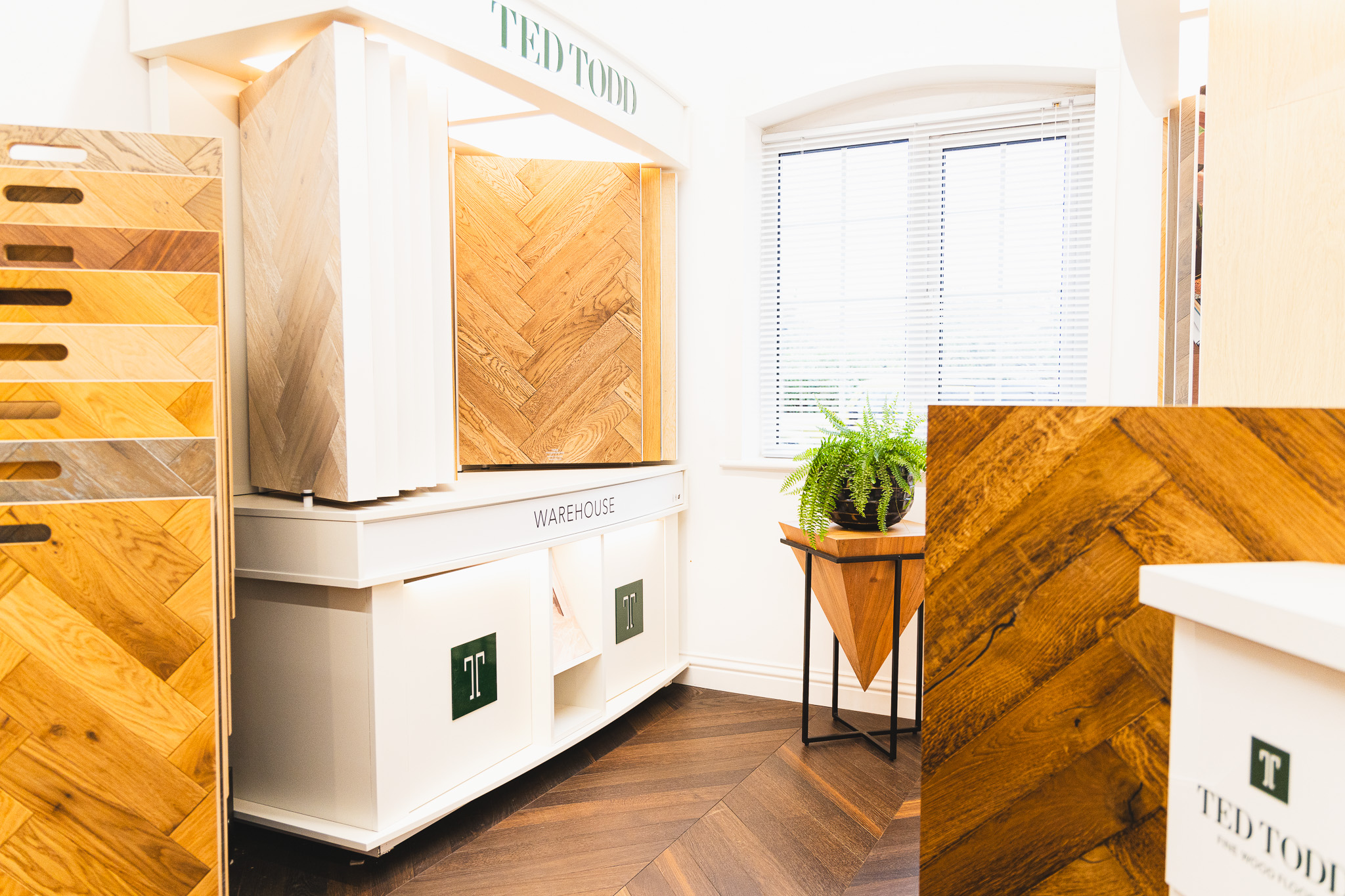 Wood floor showroom in salisbury with flooring samples in background.