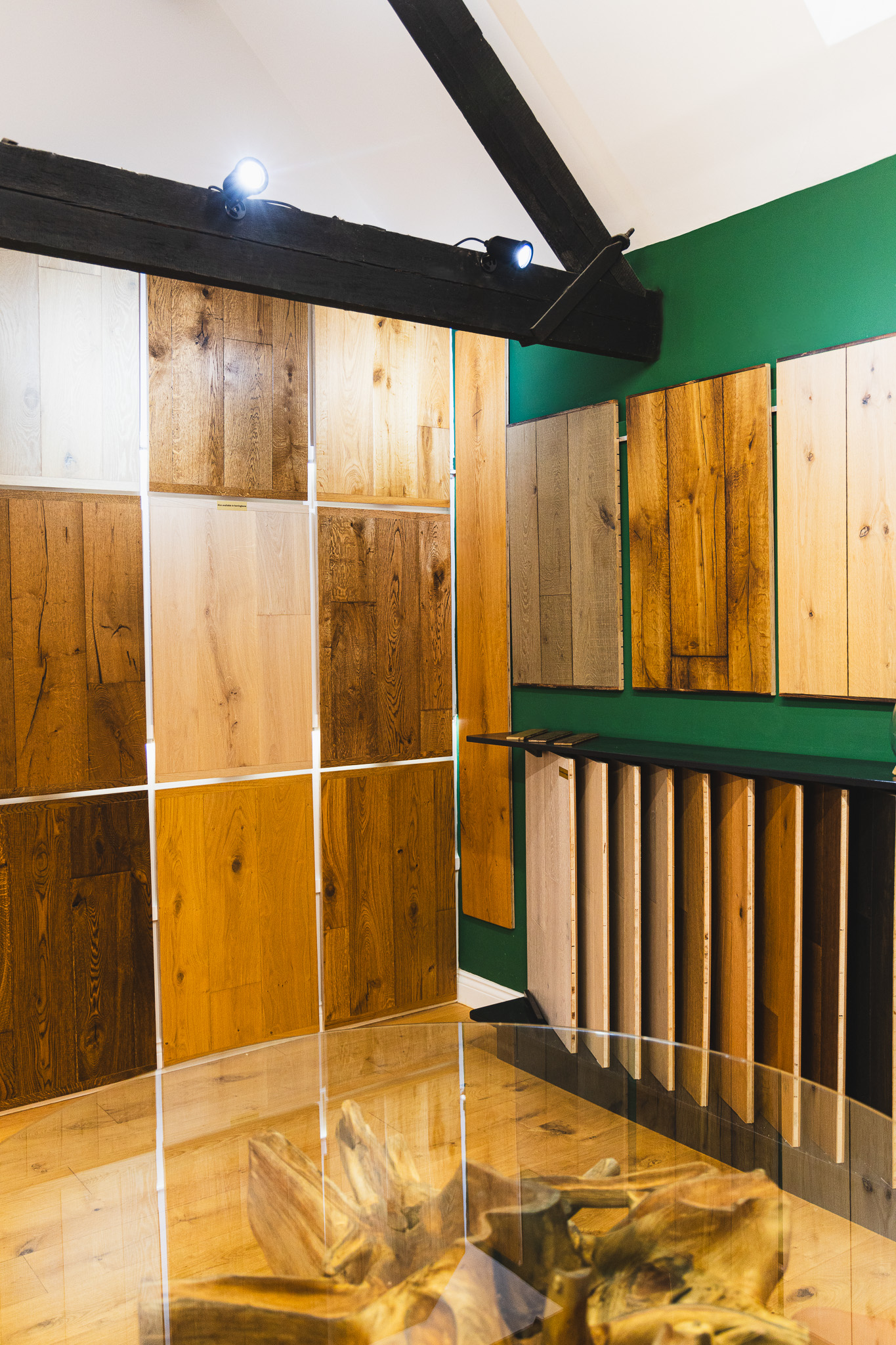 Various wood floor samples on the wall and in a stand in the showroom.