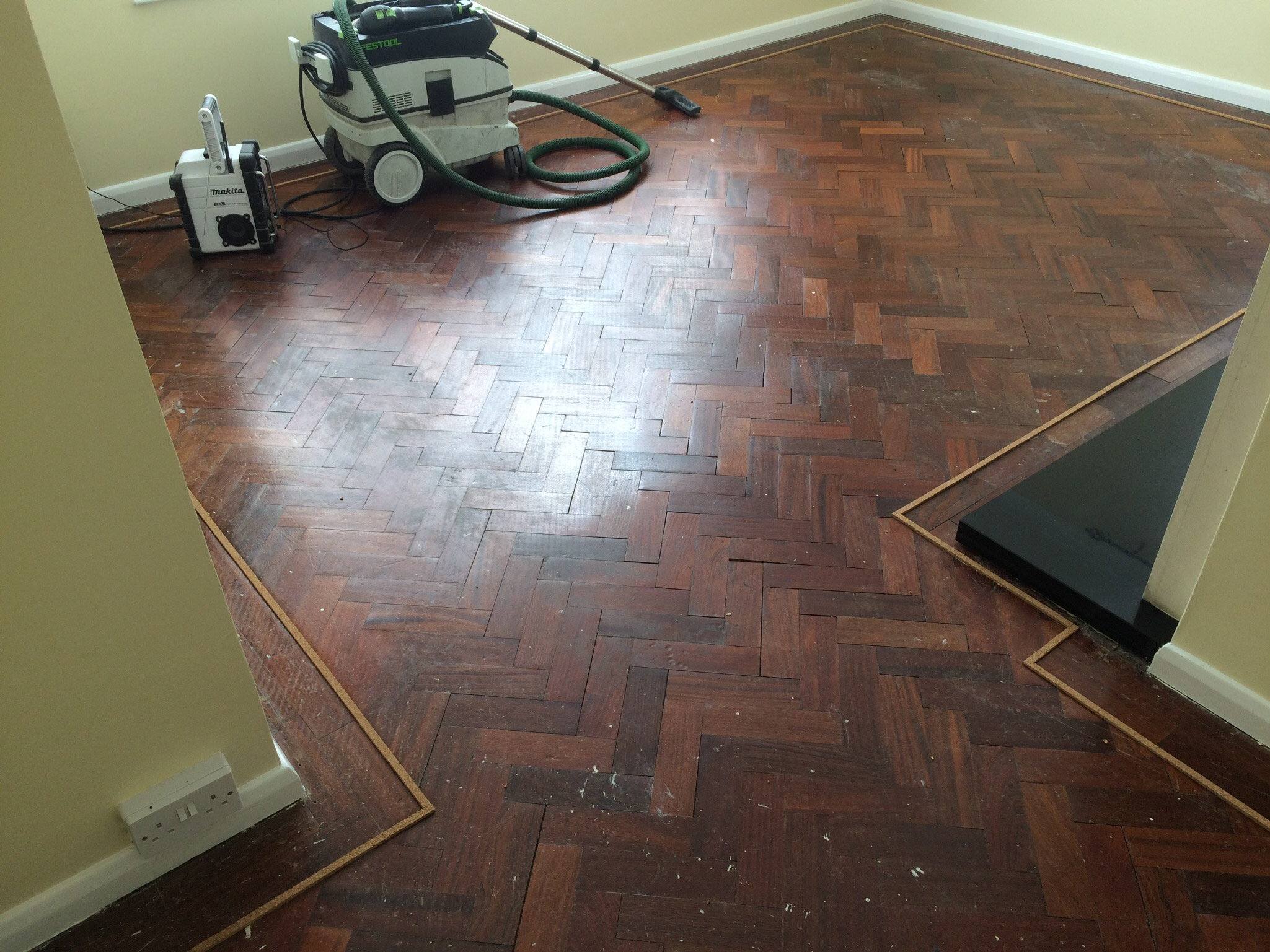 parquet herringbone flooring with cork strip replacement and repairs, sanded and sealed with Bona lacquer
