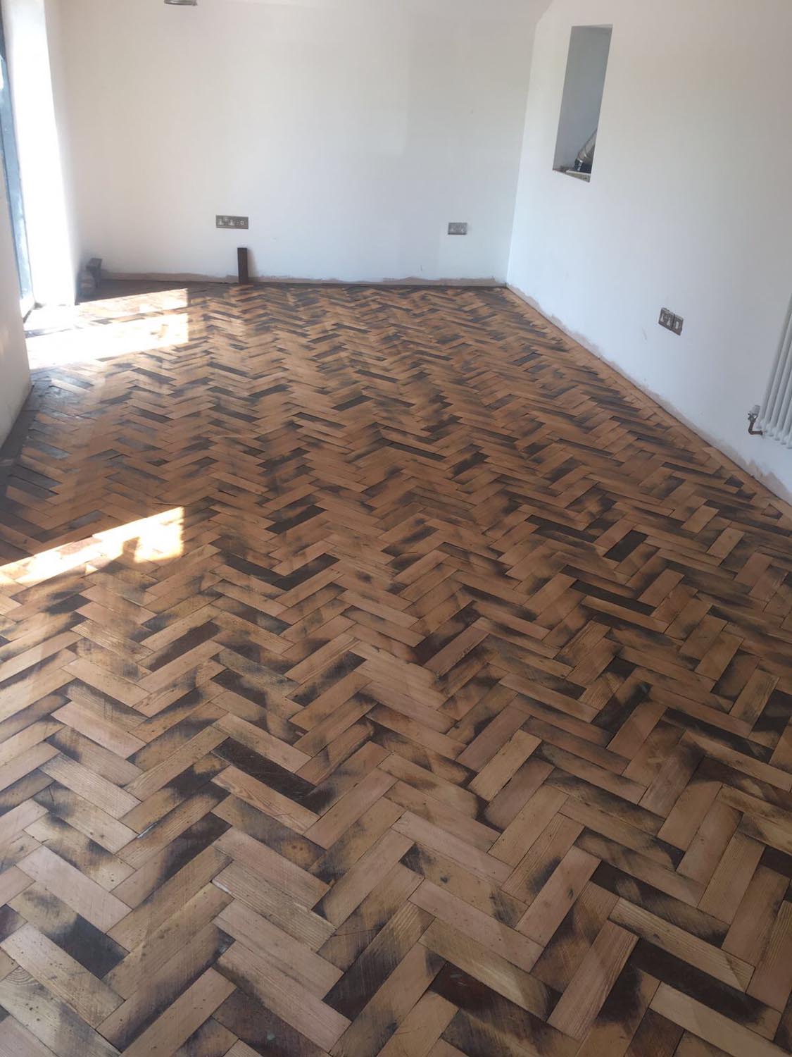 Reclaimed wood flooring pine parquet installed in herringbone style, sanding and finish in Southampton