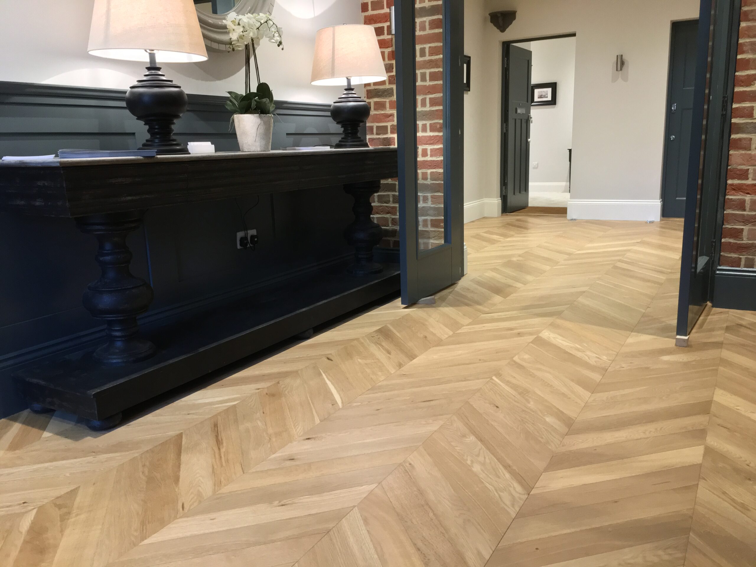 Oak chevron parquet flooring installed in downstairs of a large home.