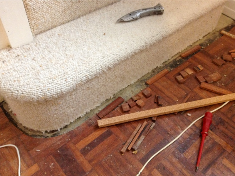 Cork strip replacement at foot of stairs before image.