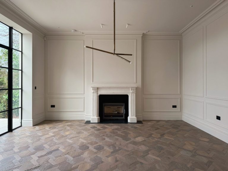 Large empty room with dark tone parquet flooring, supplied and fitted.