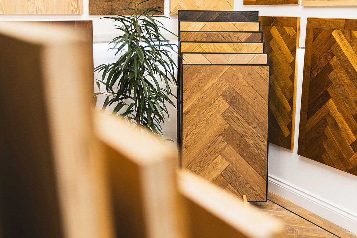 Artistic shot of salisbury wood floors showroom with lots flooring samples on the wall and leaning against it.