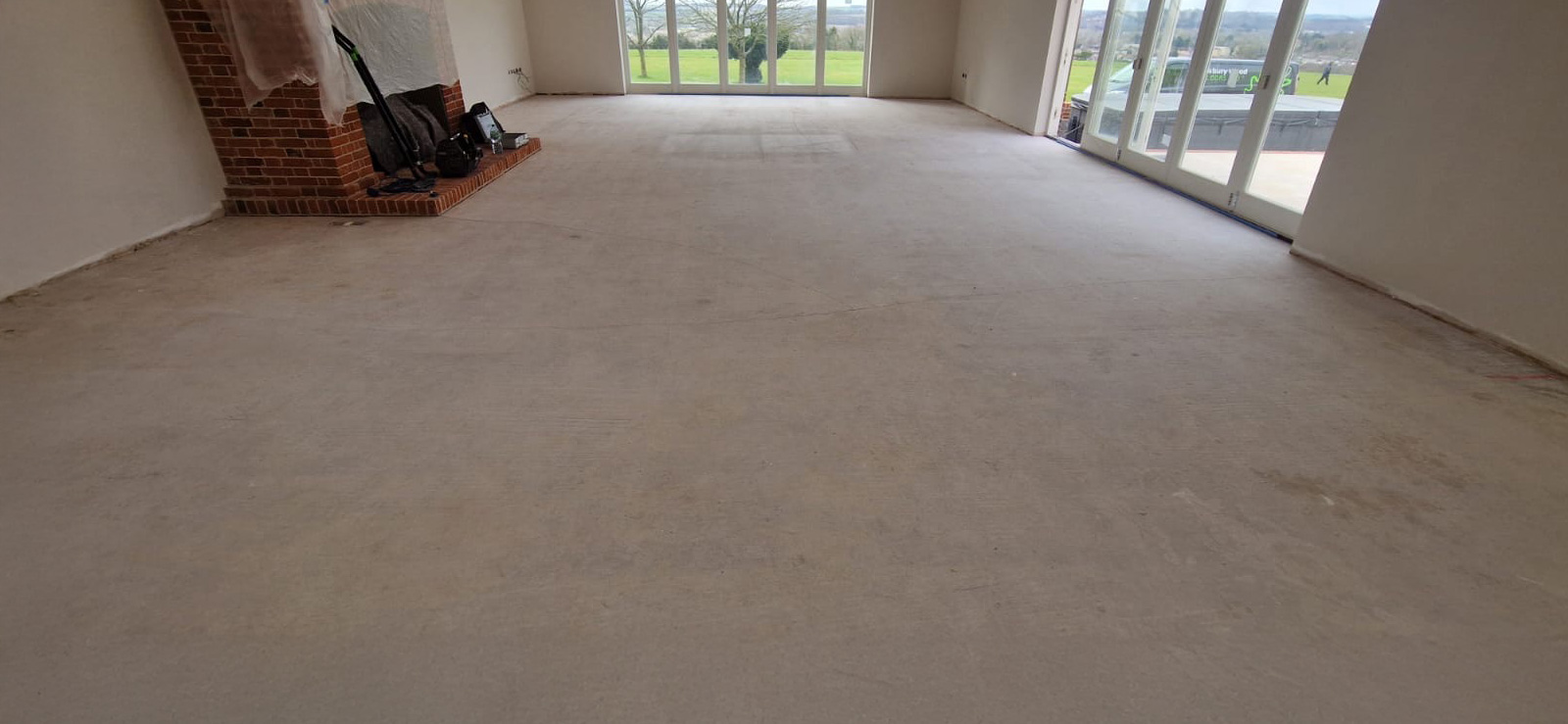 Bespoke barn grade oak 18x220mm distressed and oiled. Fitted at a 45 degree angle with solid brass inlay strips and 3 plank border plank flooring