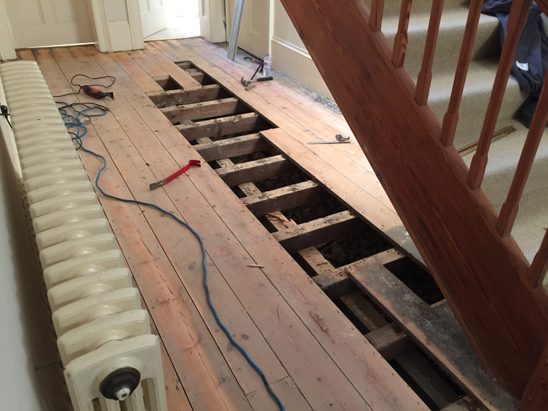 Removing rotten and damaged floorbards.