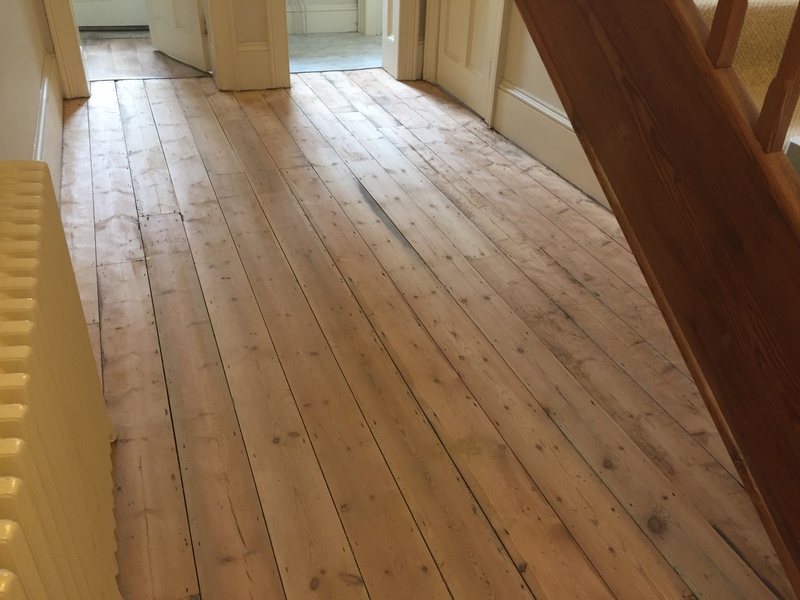 Repaired rotten and damaged floorboards with a seamless finish.