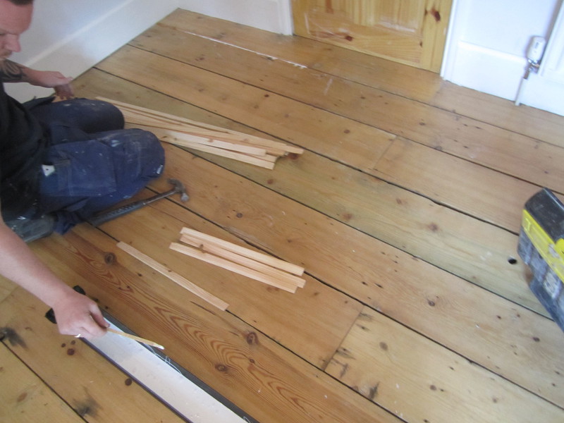 Floorboards using wood slivers for gap filling.