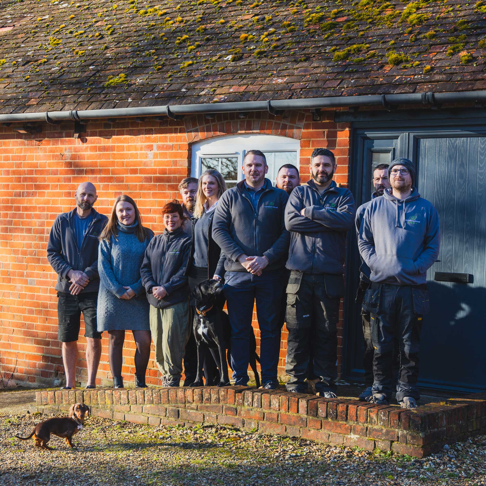 Salisbury wood floors team posing for a photo outside of their premises.