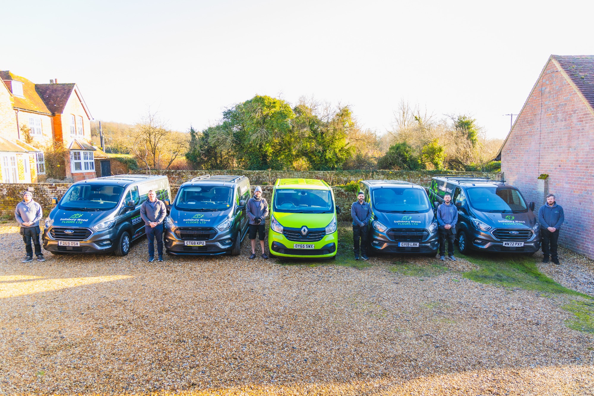Salisbury wood floor team standing individually in front of their vans.