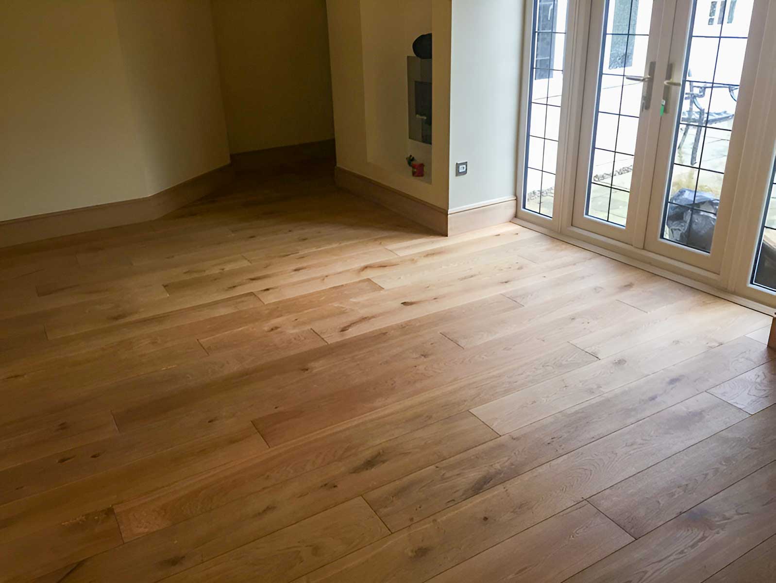 brushed and oiled oak flooring with new oak skirting - Codford