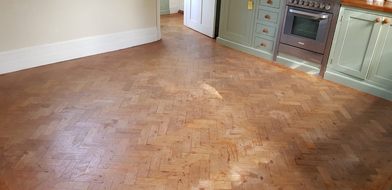 anding and finishing Teak herringbone parquet flooring in Lymington