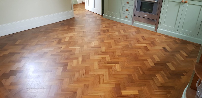 anding and finishing Teak herringbone parquet flooring in Lymington