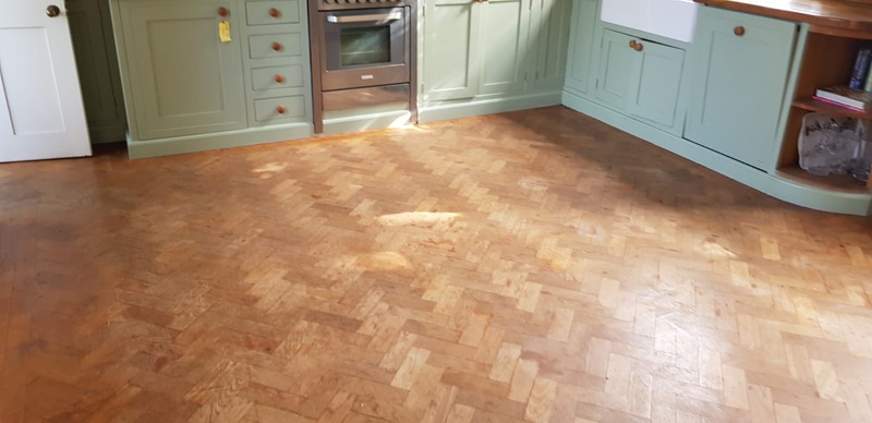 anding and finishing Teak herringbone parquet flooring in Lymington
