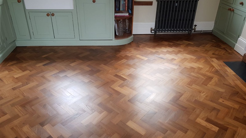 anding and finishing Teak herringbone parquet flooring in Lymington