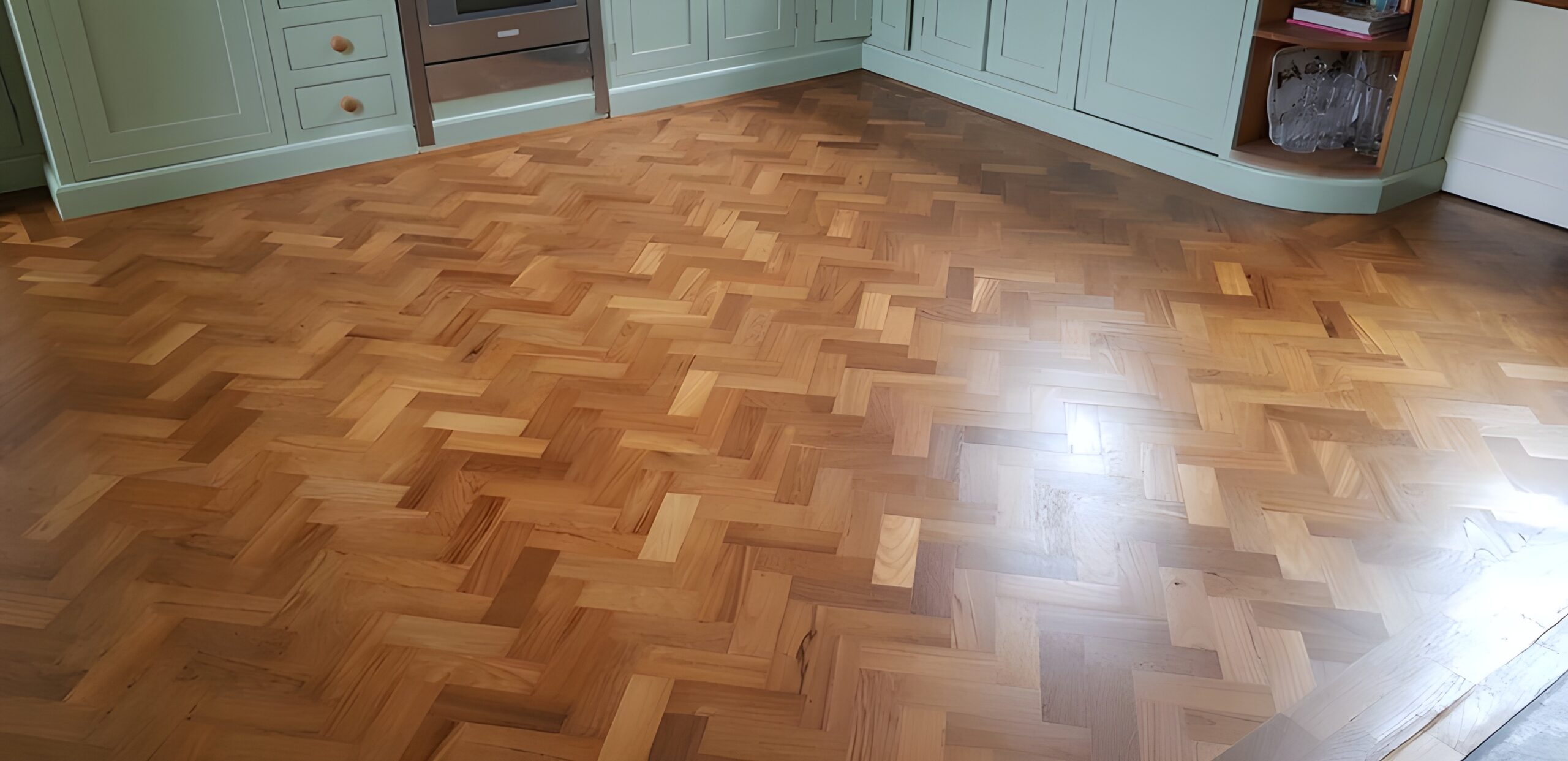 anding and finishing Teak herringbone parquet flooring in Lymington