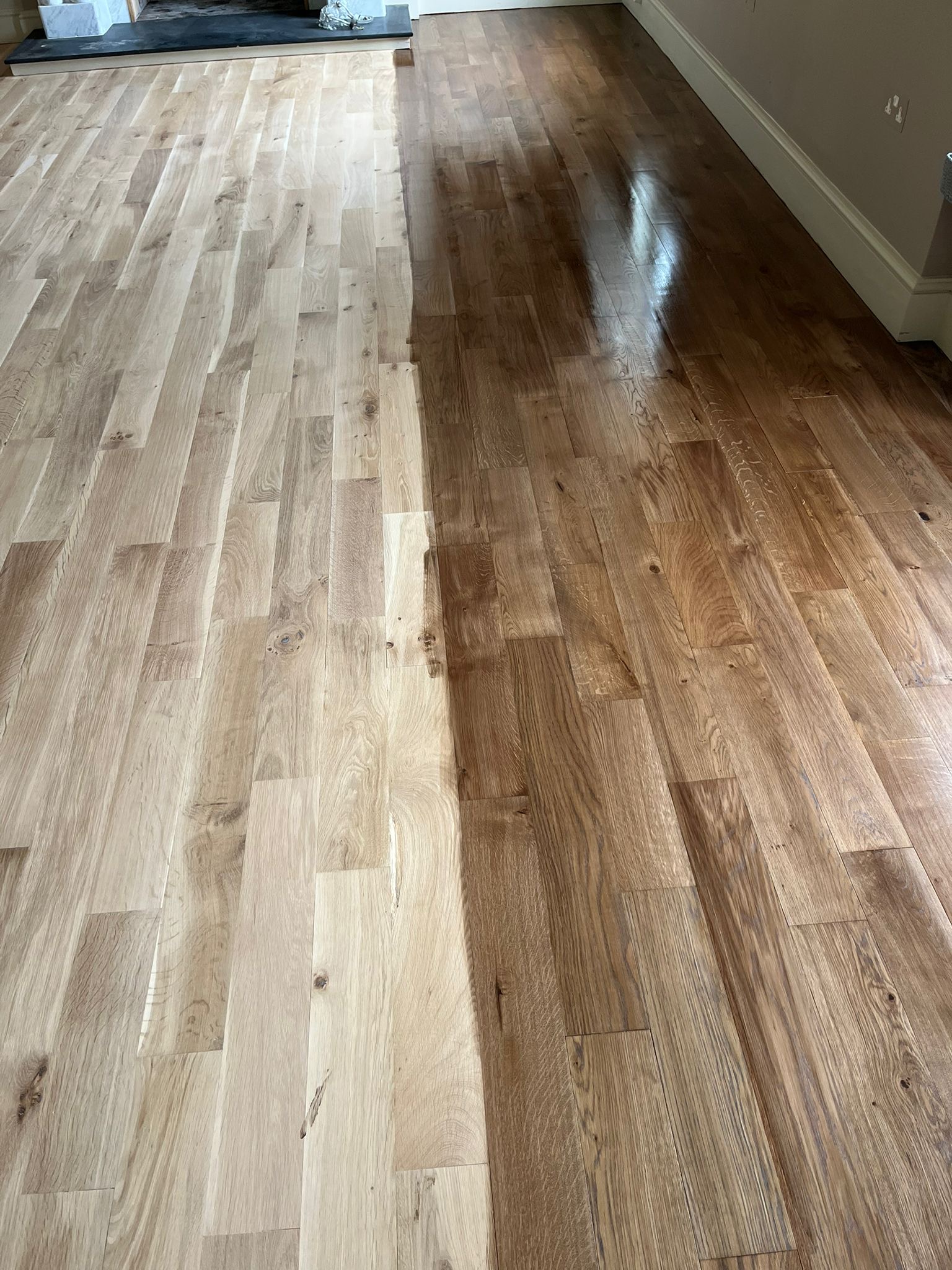 Wood floor half stained in coloured oil.